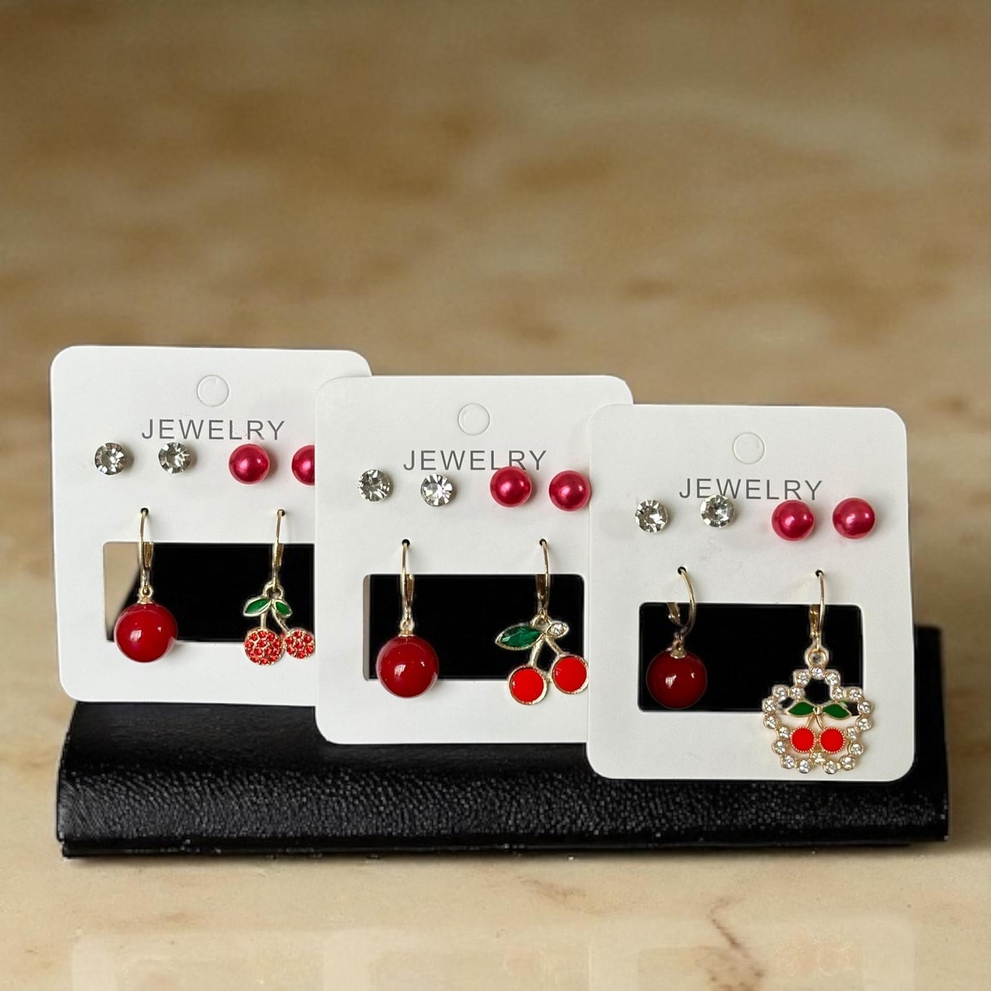 12 Sets de Aretes Cereza/ Pedreria $11.5 c/u